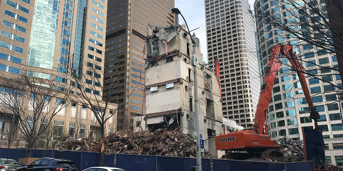 crews clean up a torn down building