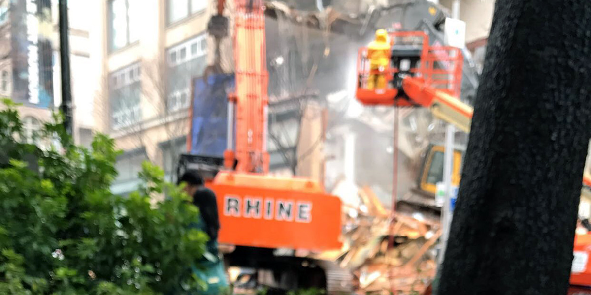 workers tear down a building