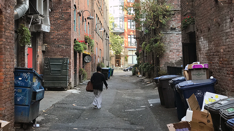 woman walking down the alley